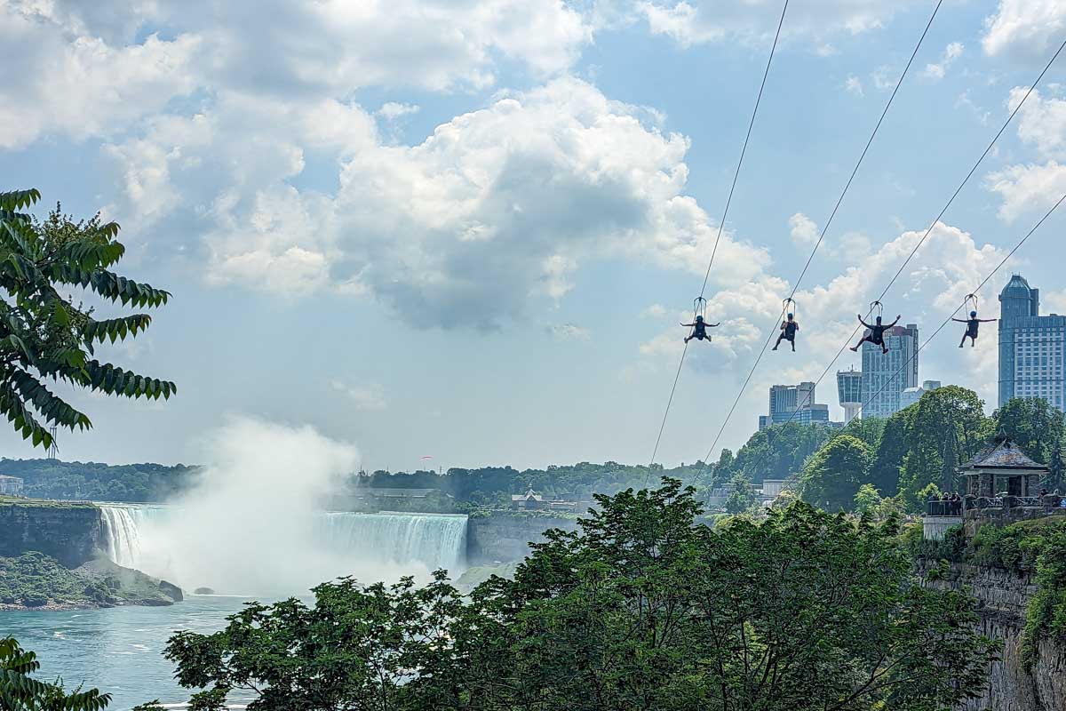 People zipline towards Niagara Falls Canada