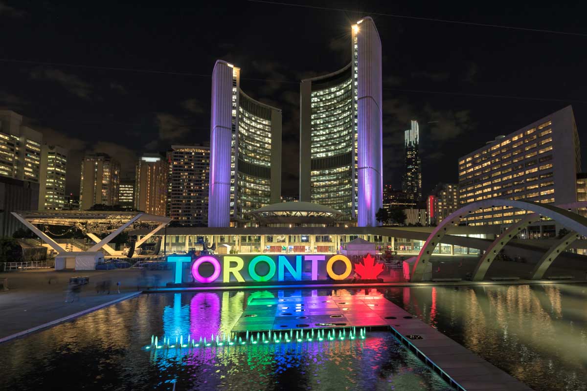 The Toronto Sign lit up at night in Toronto Downtown
