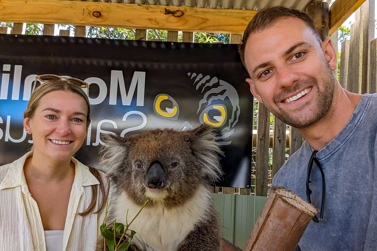 Bailey and Daniel smile with a koala at the moonlit sanctuary on phillip island during a go west penguin tour near melbourne australia