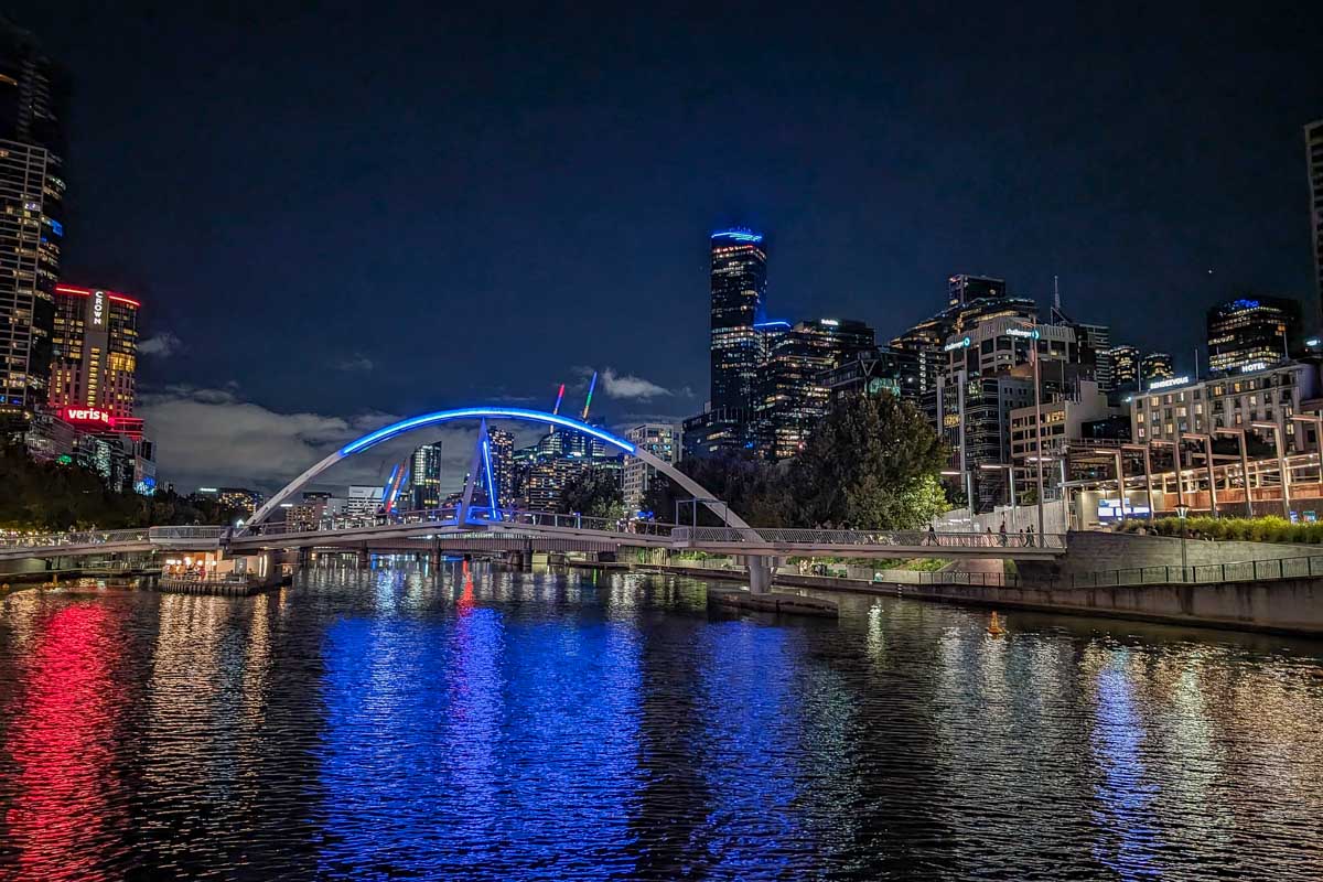 Melbourne and a lit bridge at night on the spirit of melbourne cruise