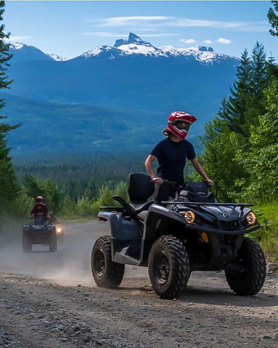 A woman rides an ATV in the mountains on a tour with Whistler ATV Ltd