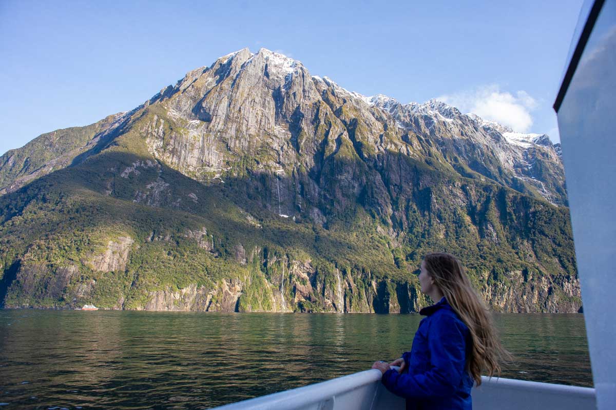 Bailey looks at a snow covered mountain on the milford sound nature cruise new zealand