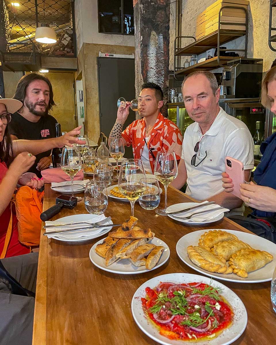 People listen to a food guide on a sherpa food tour in Buenos Aires Argentina