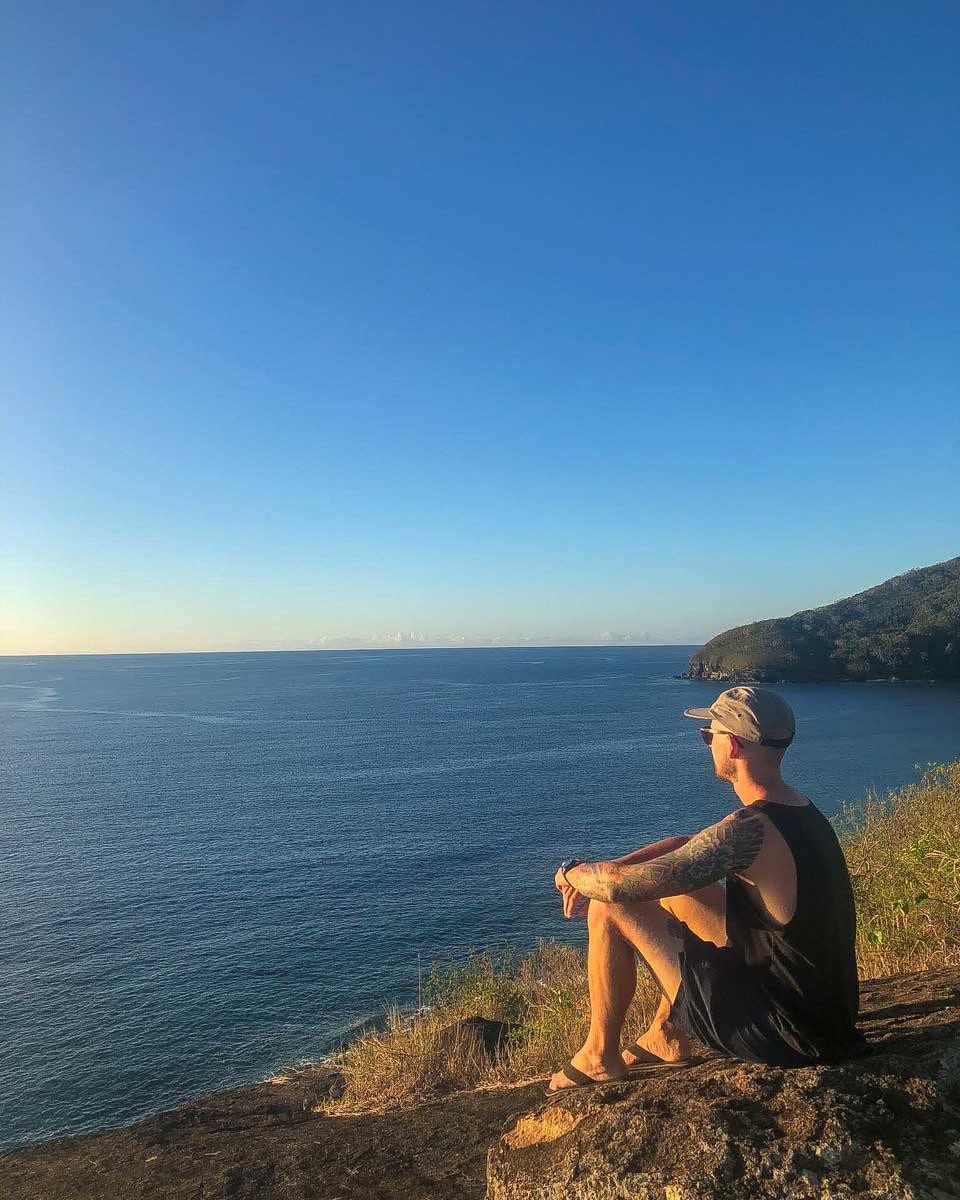A man enjoys sunset at a view point while staying at Waya Lailai Eco Haven Fiji