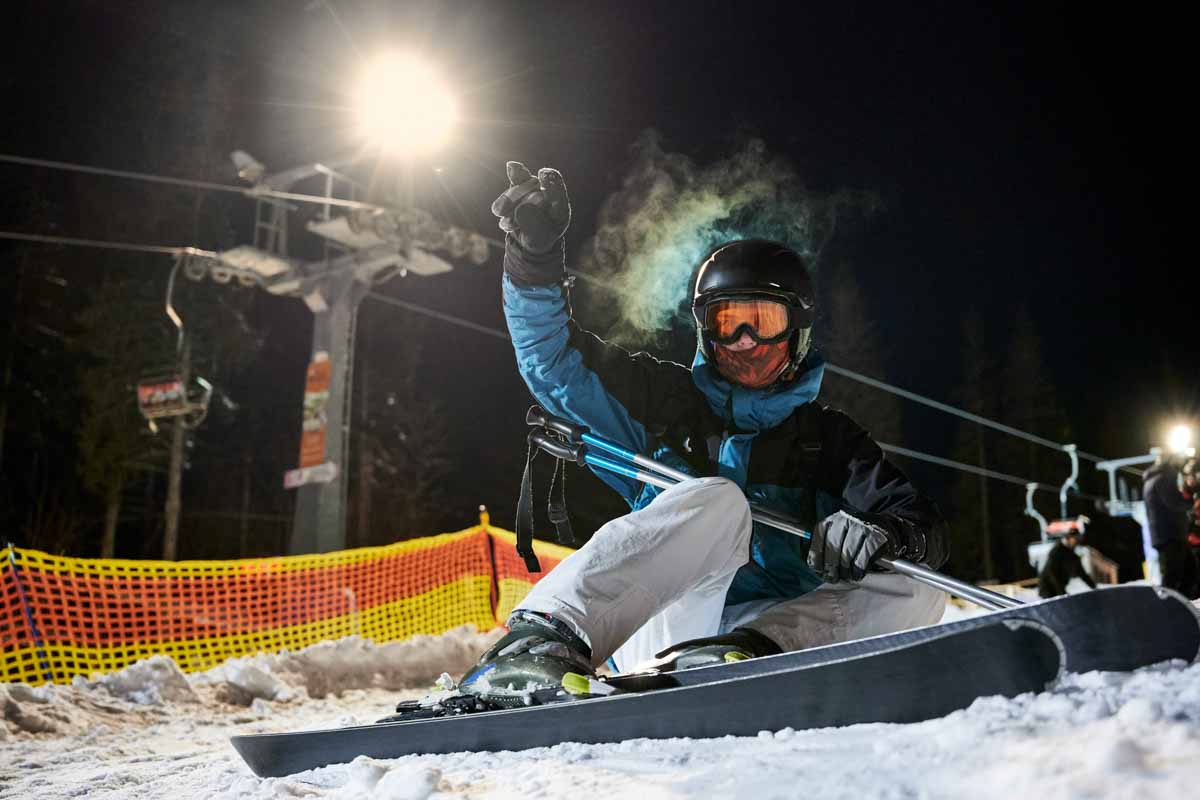 A man skis at Mt Norquay at night