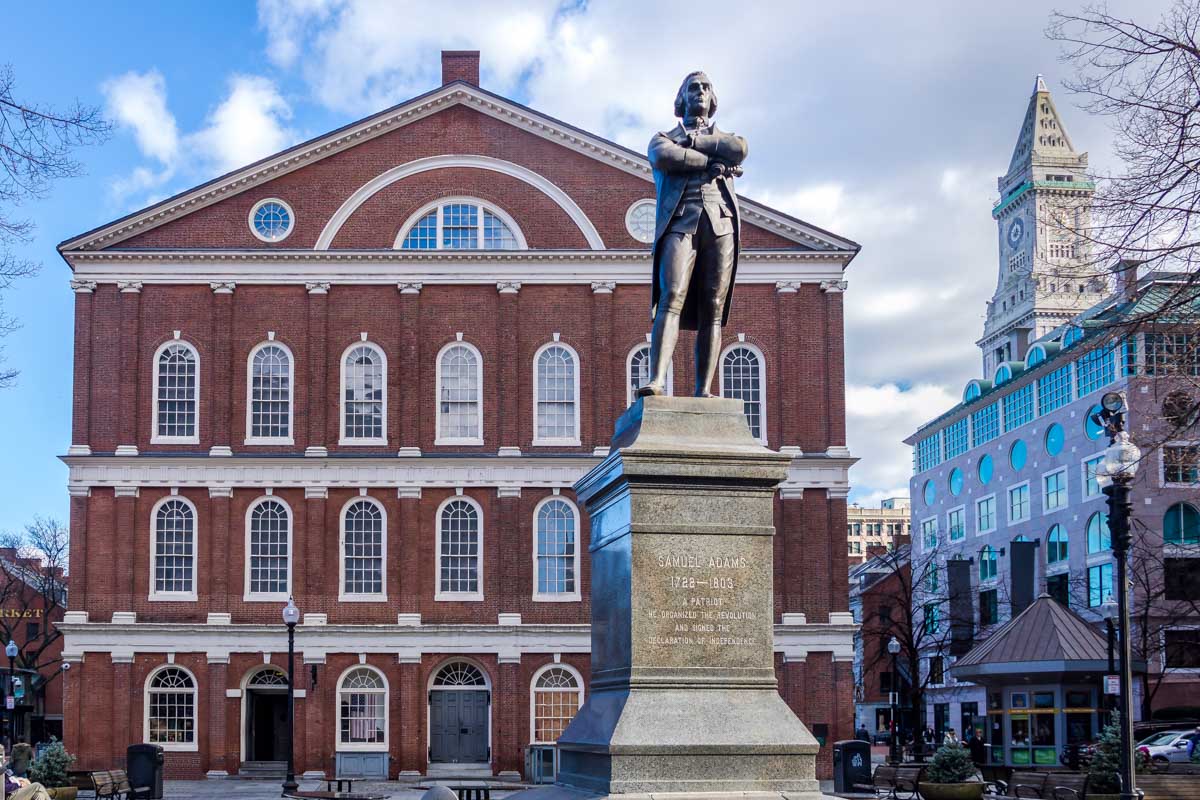 A statue of Samuel Adams in front of Faneuil Hall Boston