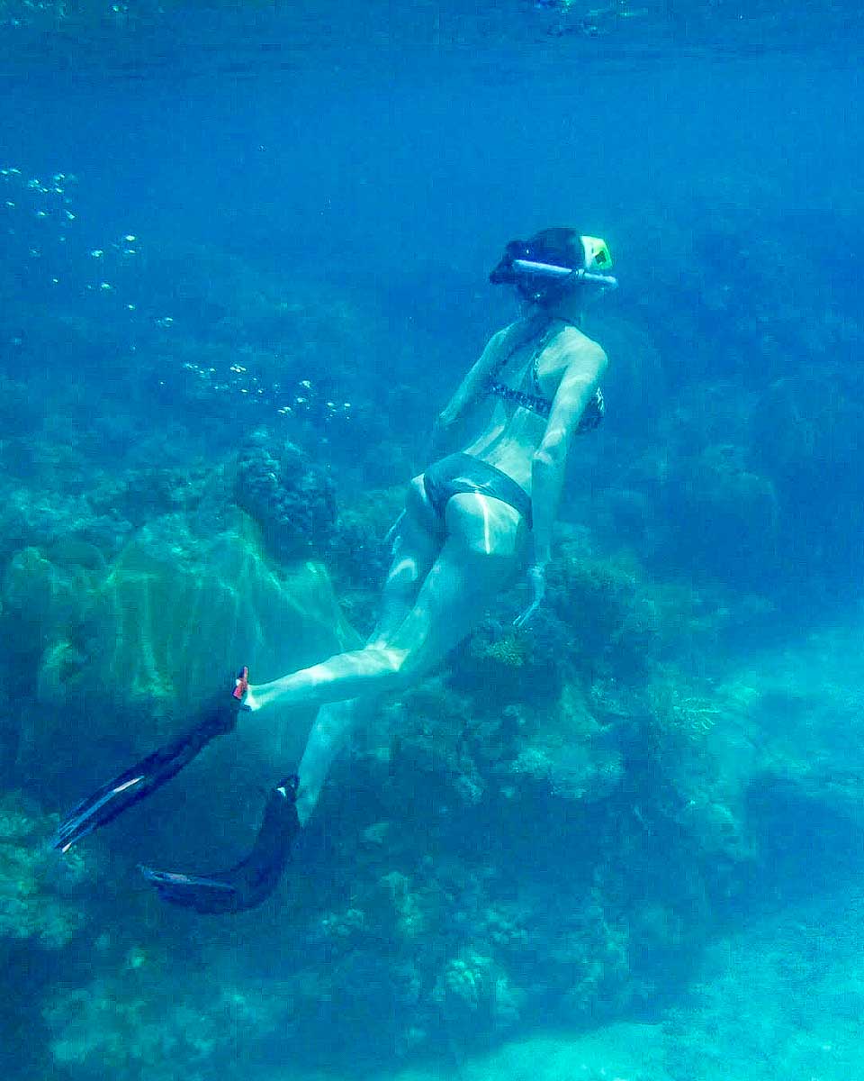 A woman snorkels at Paradise Cove Resort Fiji