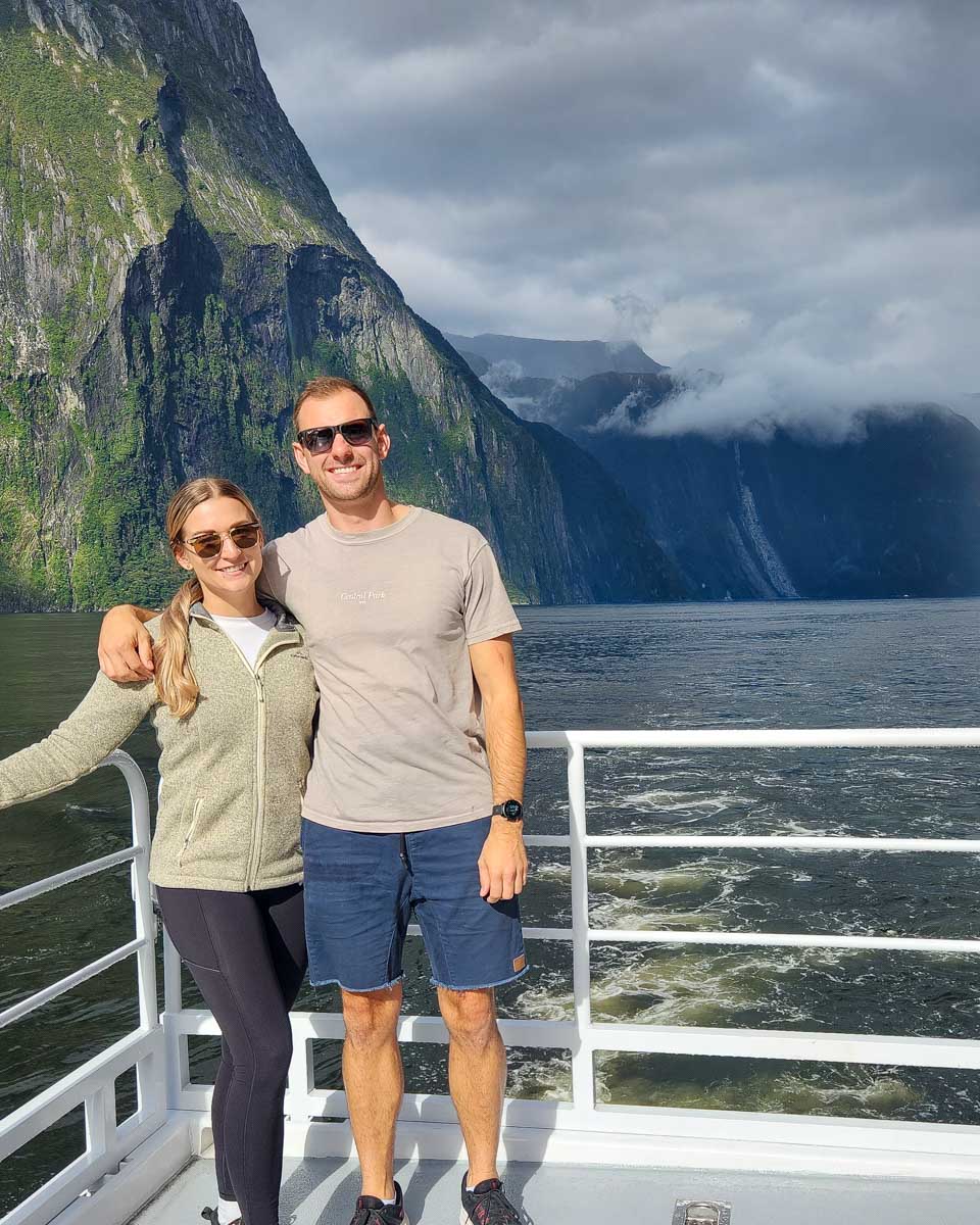 Bailey-and-Daniel-pose-on-a-boat-cruise-of-the-Milford-Sound-New-Zealand through get your guide