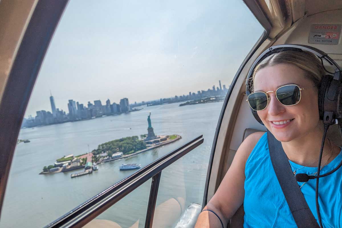 Bailey-with-the-Statue-of-Liberty-and-New-York-City-in-the-background-on-a-helicopter-ride through get your guide