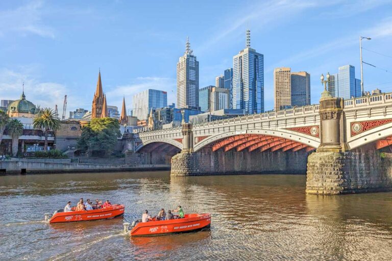 Two river boat rentals travel down the Yarra River in Melbourne City center