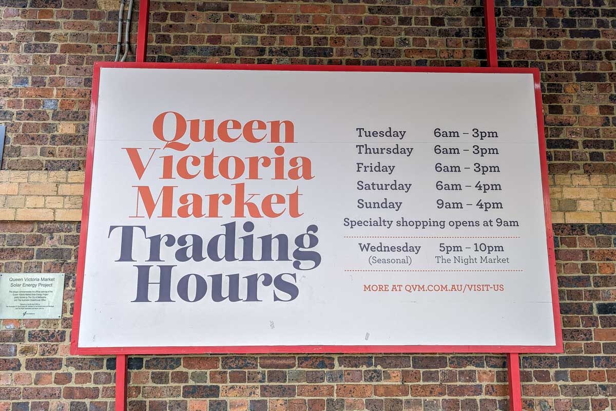 A sign showing what times the market is open at the Queen Victoria Market in Melbourne Australia
