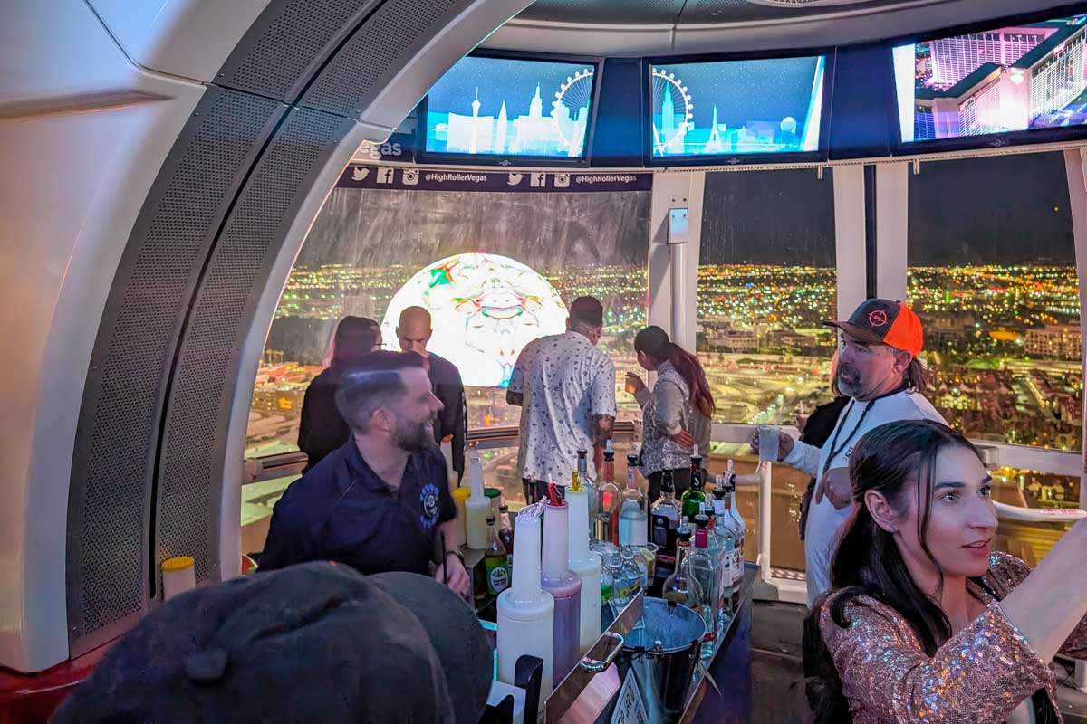 A bartender makes drinks for people on the High Roller Las Vegas