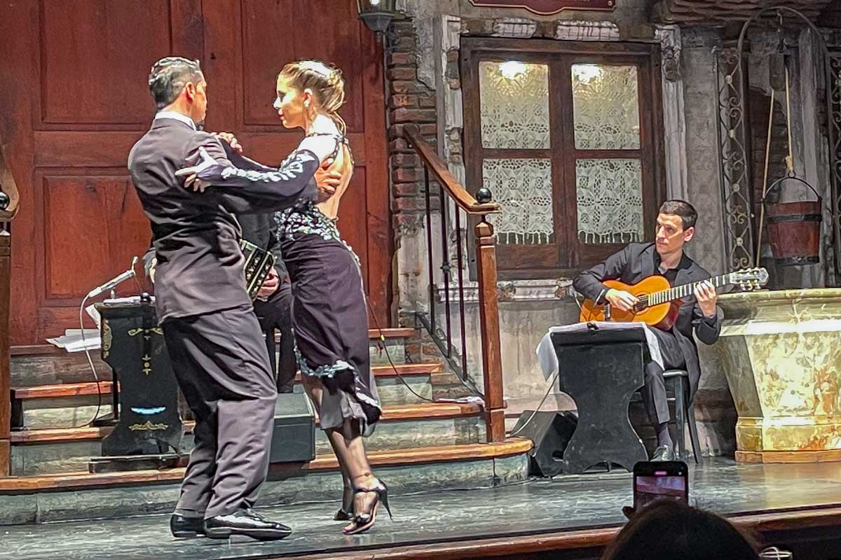 A man and woman tango in suits at La Ventana Buenos Aires Argentina
