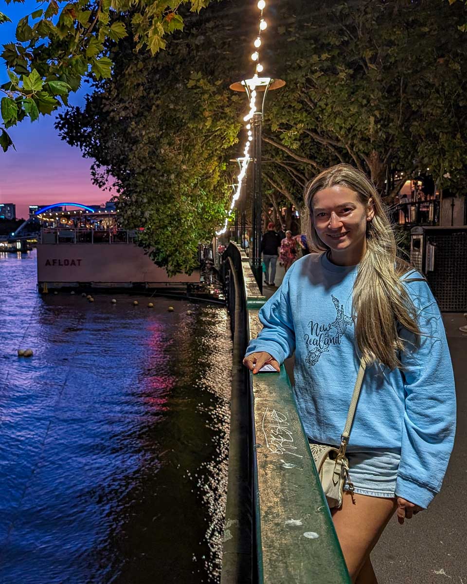 Bailey stands by the Yarra river in Melbourne Australia at night