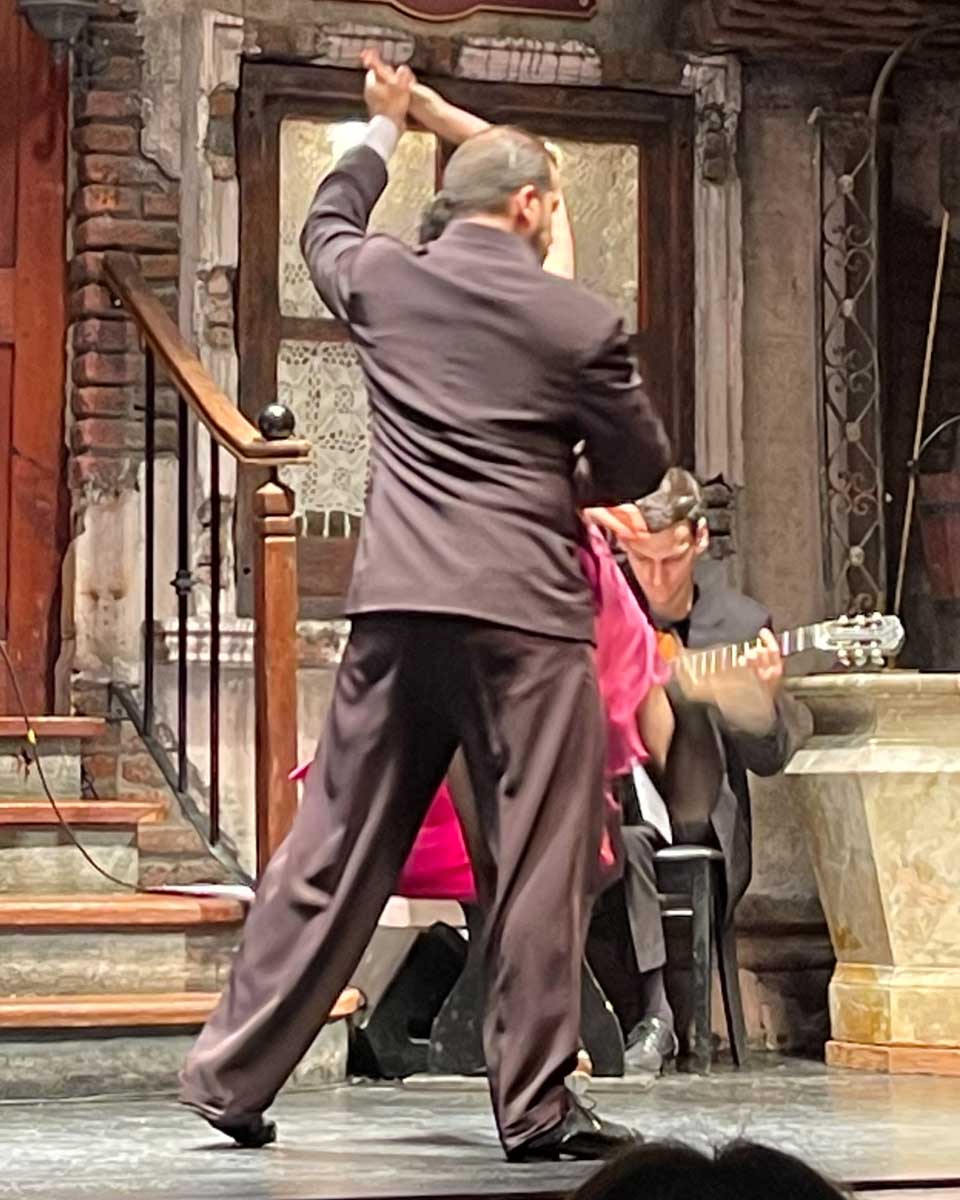 Couple does tango with backs turned at La Ventana Buenos Aires Argentina