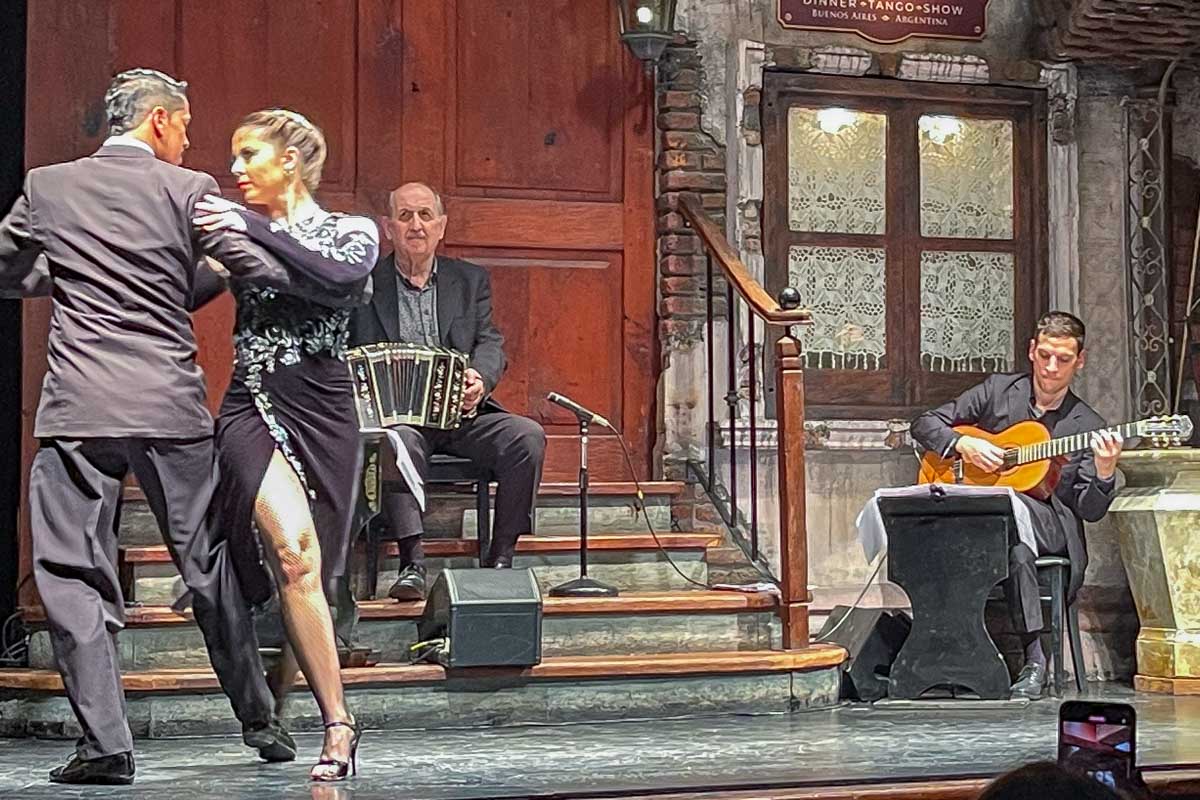 Two people tango with musicians at La Ventana Buenos Aires Argentina