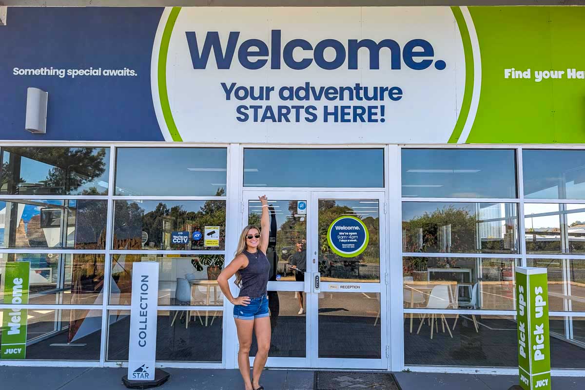 Bailey Stands at the front of the JUCY pick up area in Australia