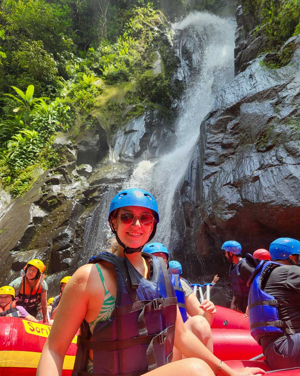 Bailey in a raft by a waterfall in Bali