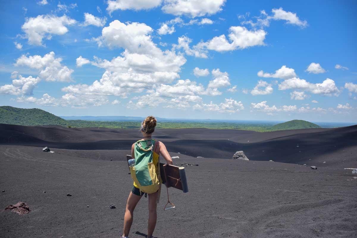 Bailey stands with her volcano board at the base of cerro negro Nicaragua
