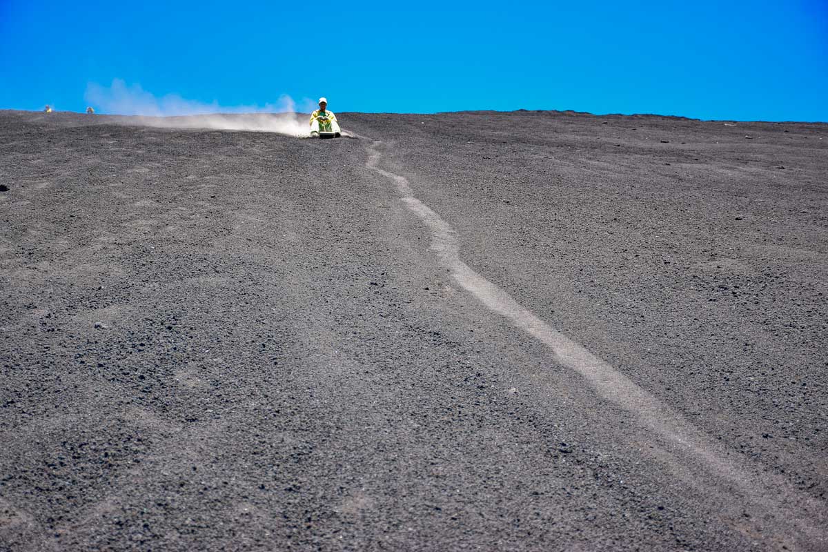 Daniel comes down the cerro negro volcano boarding slope in Nicaragua