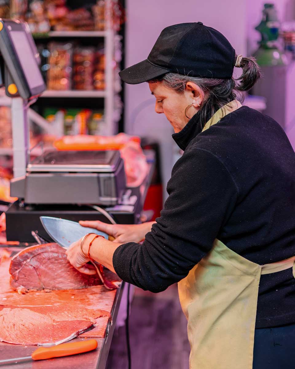 A woman cuts meat in Barcelona Spain