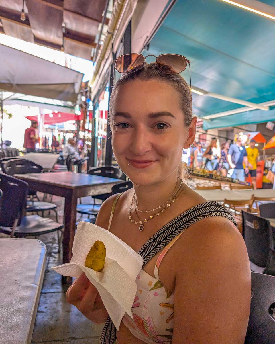 Bailey-holds-food-on-a-food-tour-in-Bogota