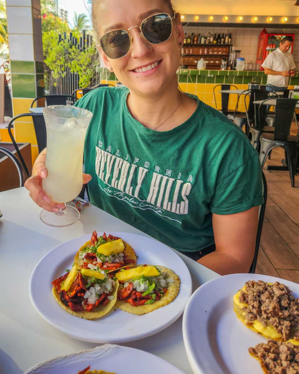 Bailey-with-her-tacos-and-margarita-on-a-taco-tour-in-oaxaca