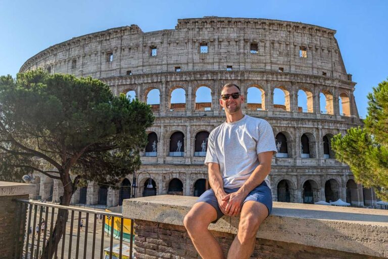Daniel sitting outside of the colosseum in Rome Italy-2