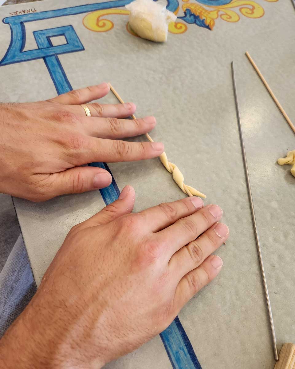 Someone rolling dough during a cooking class in Taormina Italy