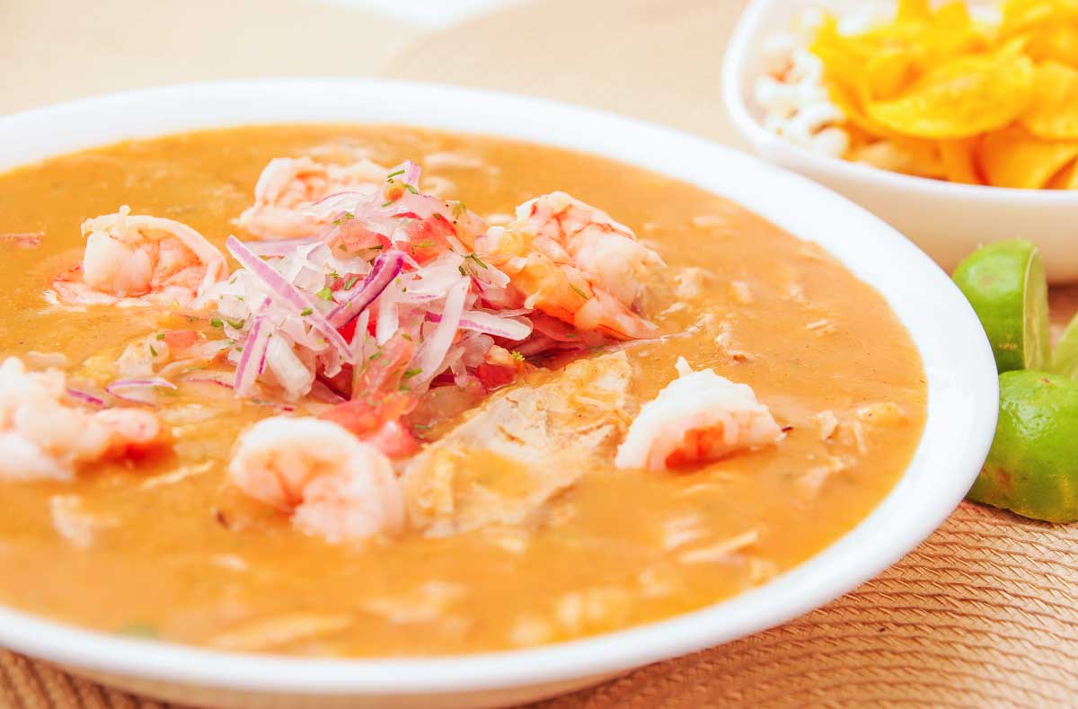 Close up of selective focus of Ecuadorian food: shrimp cebiche with some blurred chifles background