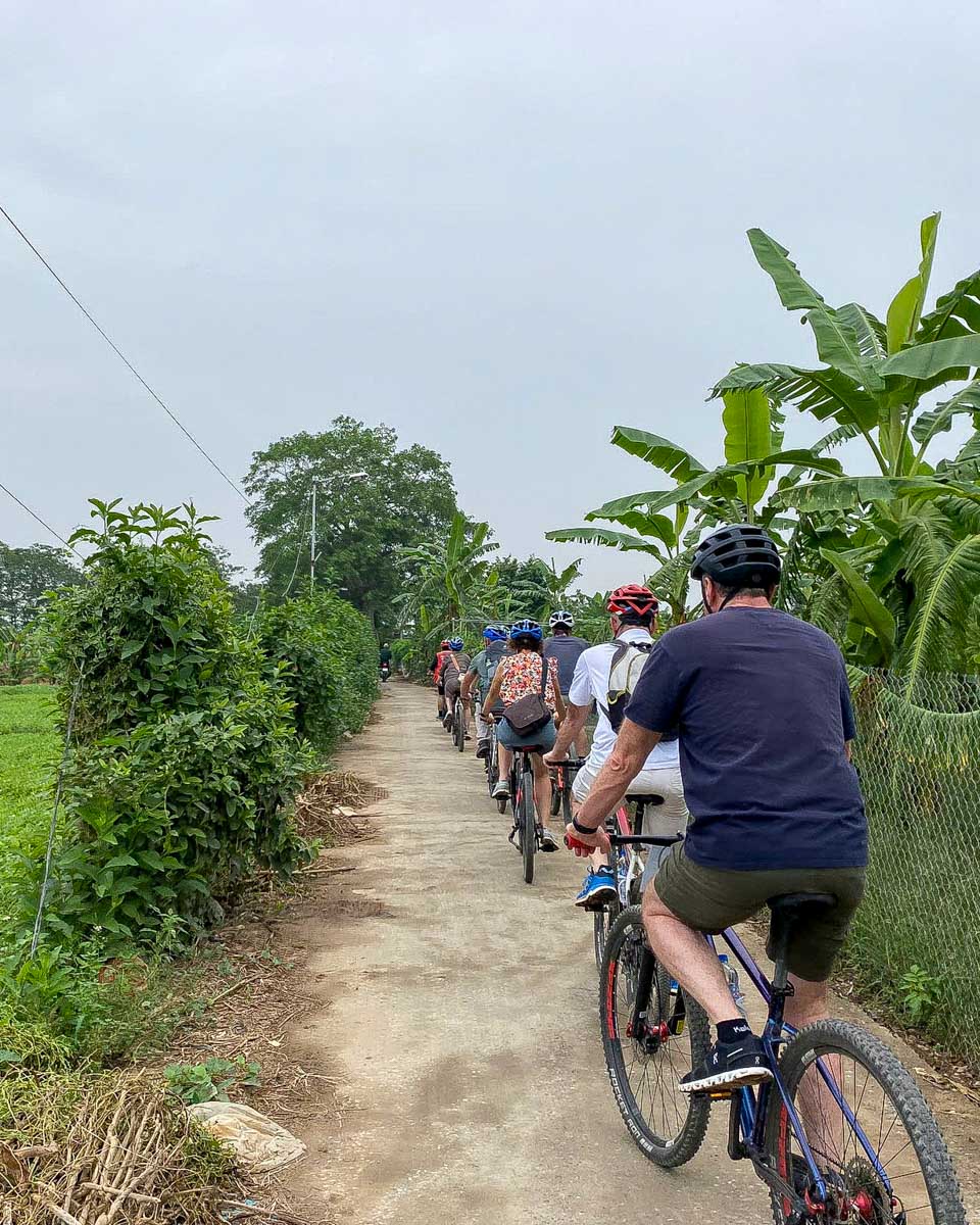 Bike Tours Hanoi people ride through the countryside near Hanoi Vietnam