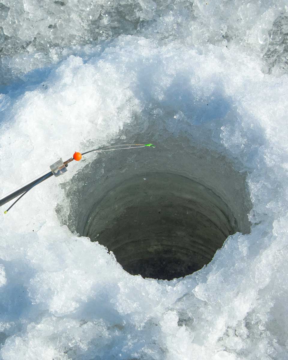 Ice fishing hole on a tour from Tromso Norway