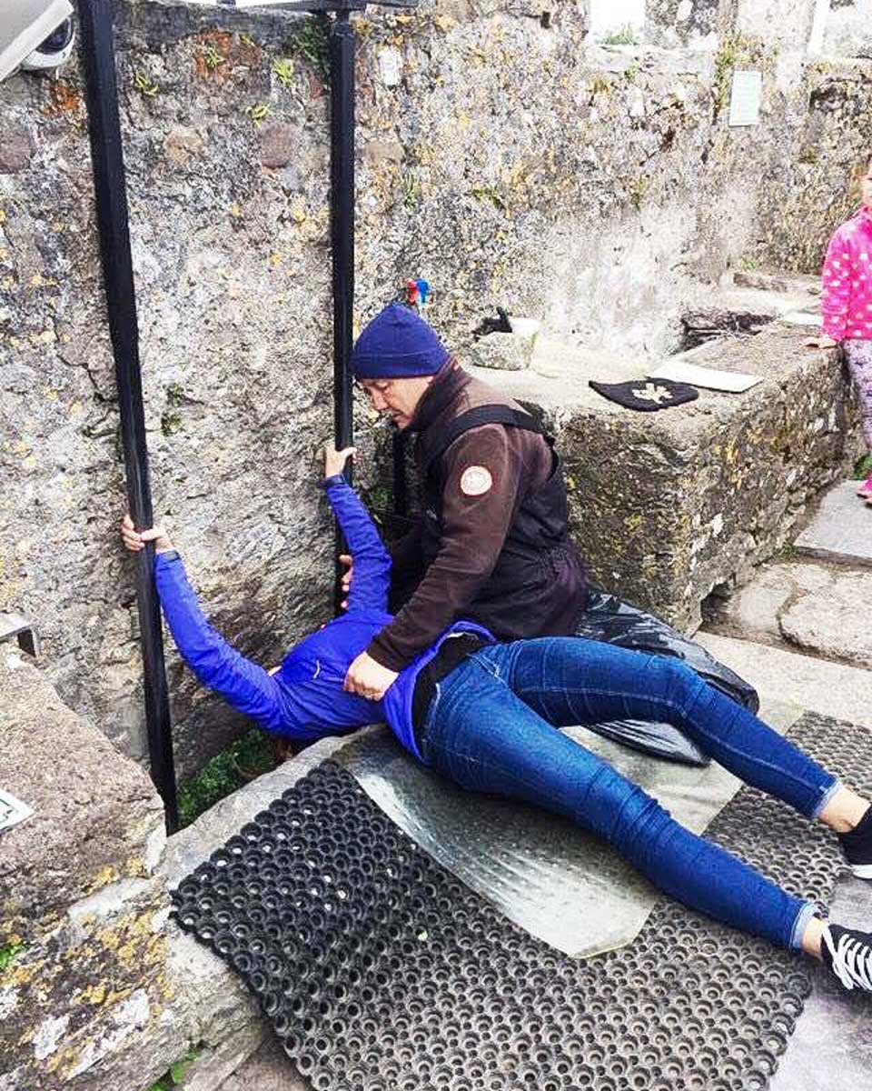 Paddywagon Tours kissing the Blarney stone on a tour from Dublin Ireland