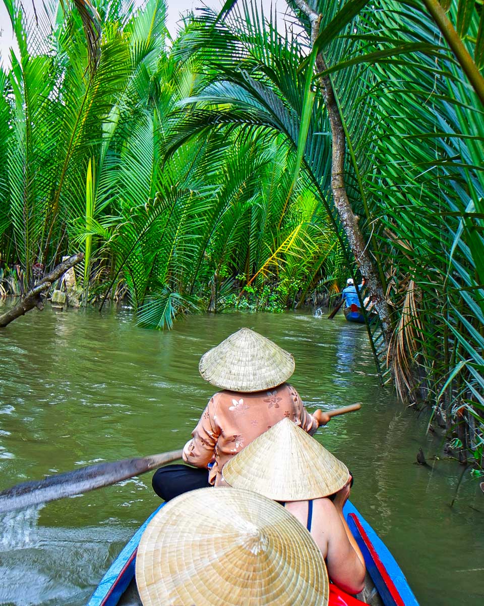 People in boats go down the Mekong Delta on a tour from Saigon Ho Chi Minh Vietnam