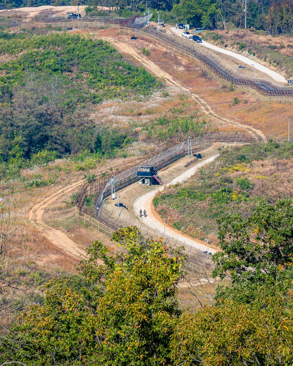 Soldiers patrol the border at the DMZ seen from the Dora Observatory on a tour from Seoul South Korea
