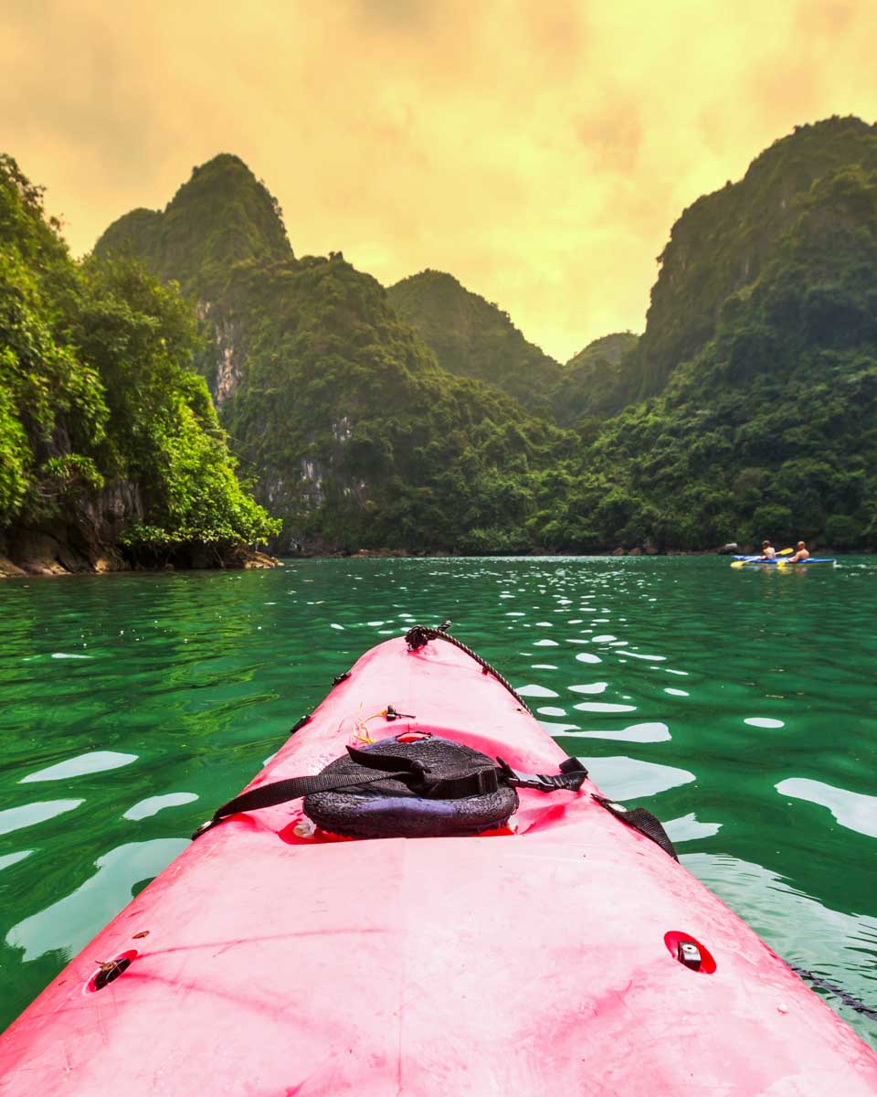 Sunset kayaking through Ha Long Bay on a cruise in Vietnam