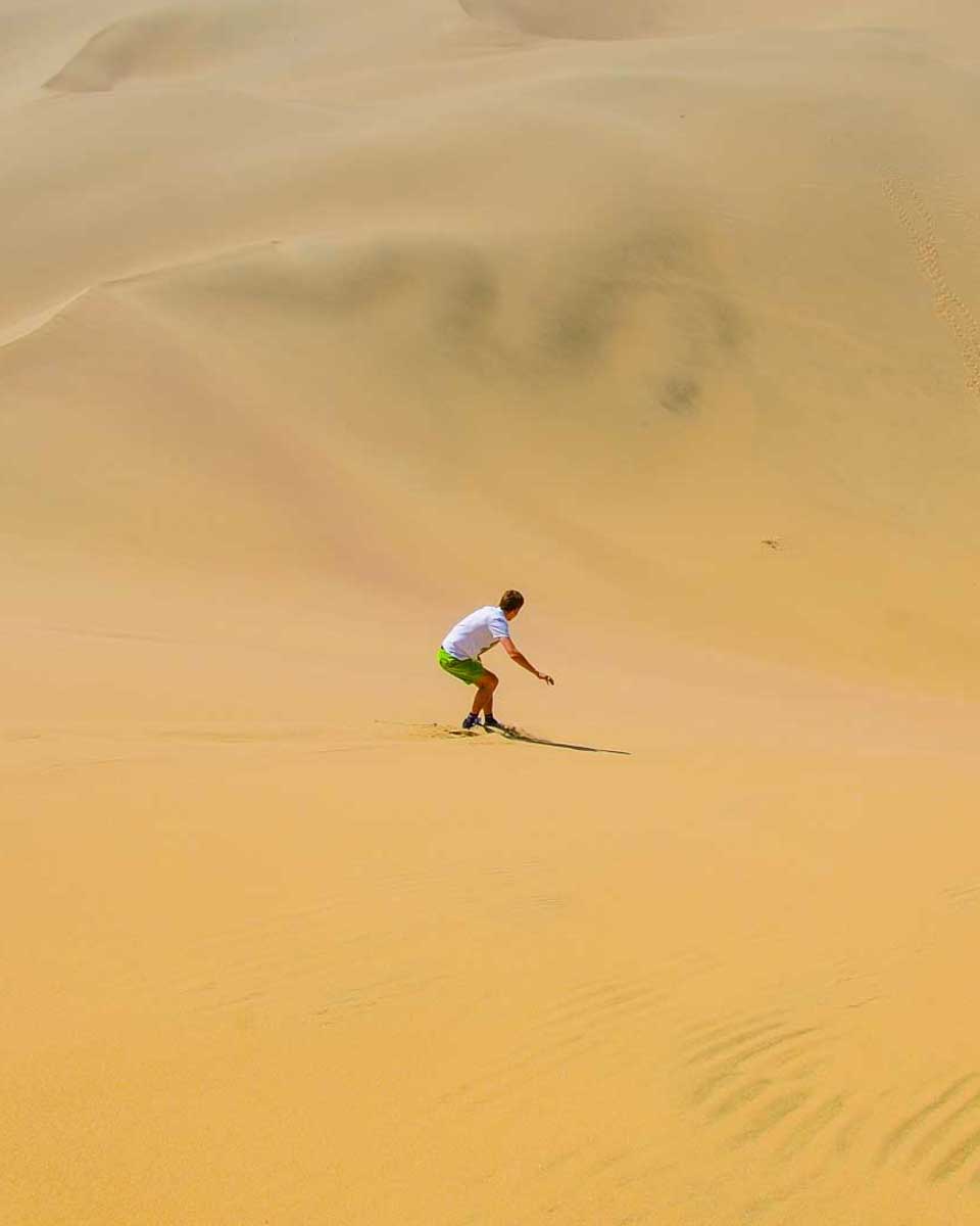 A-person-sand-boards-on a desert safari in Cairo Egypt