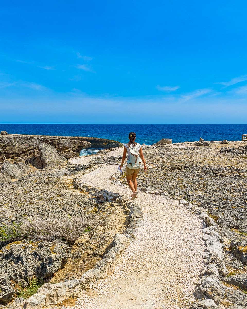 A woman walks at Shete Boca National Park seen on a tour in Curacao