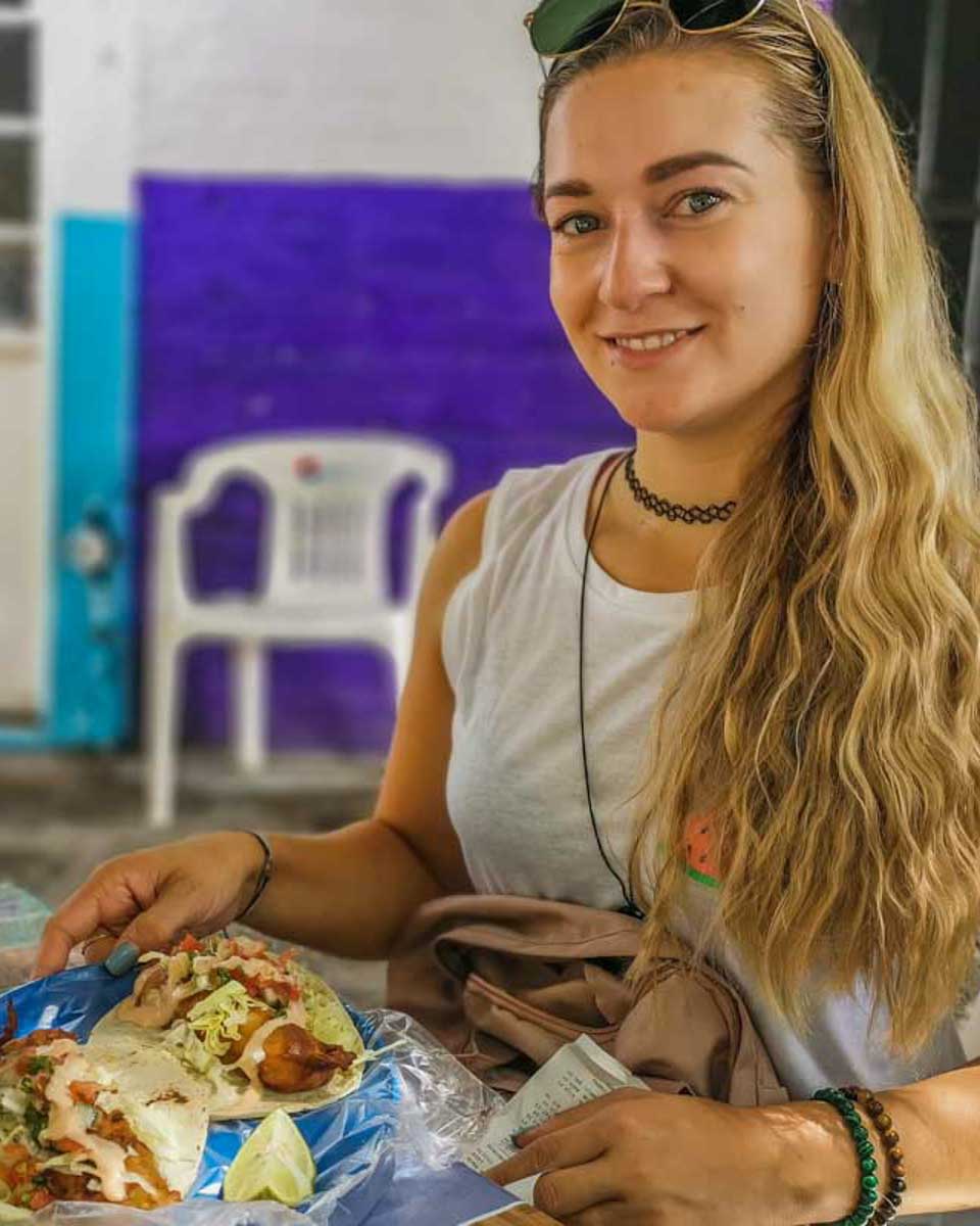 Bailey-with-a-taco-on-a-food-tour-in-St Thomas Virgin Islands