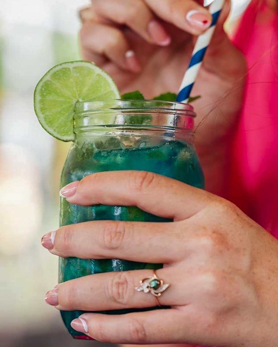 Landhuis Chobolobo a person drinks a cocktail on a tour in Curacao