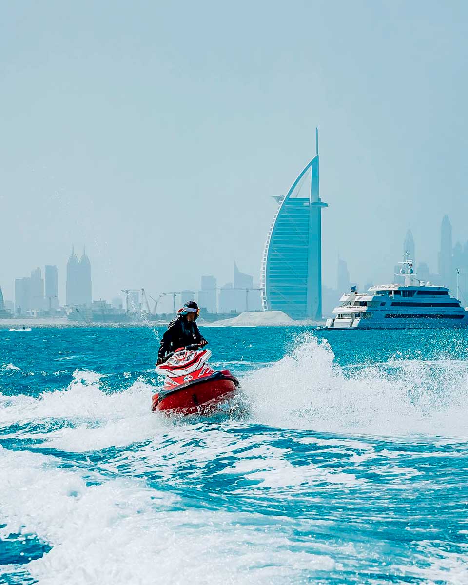 Popeye Jetski a person jet skis in the Dubai Marina in Dubai with boat in the back