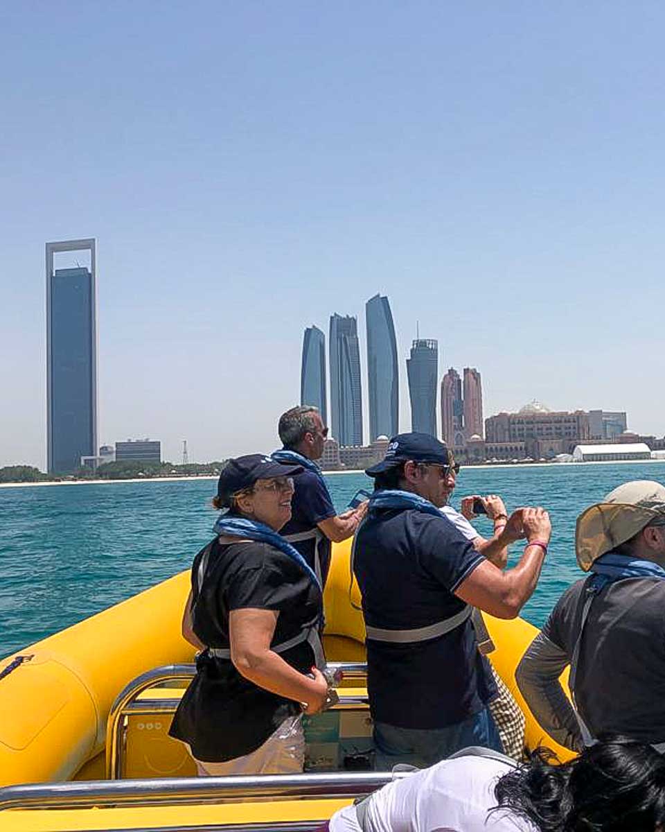 The Yellow Boats people take photos on a boat tour in Abu Dhabi