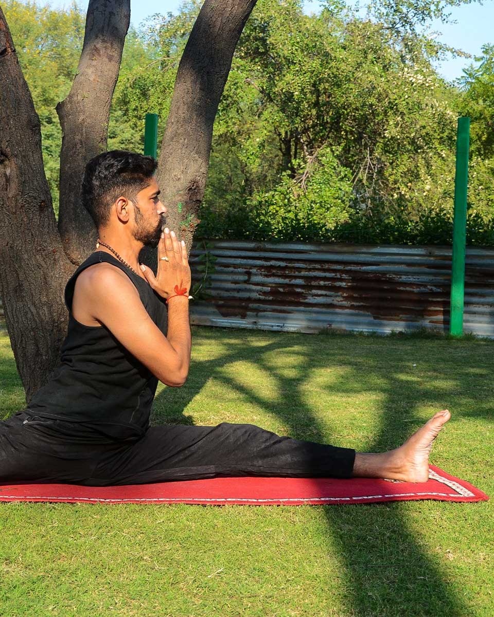 Yoga Tours by India a man does yoga in New Delhi