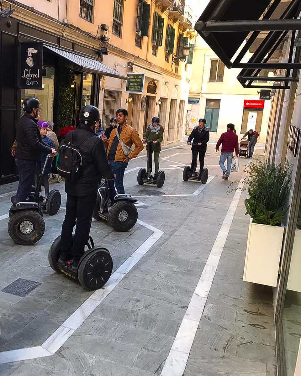 A group of people riding Segways down a street in Malaga, Spain 2