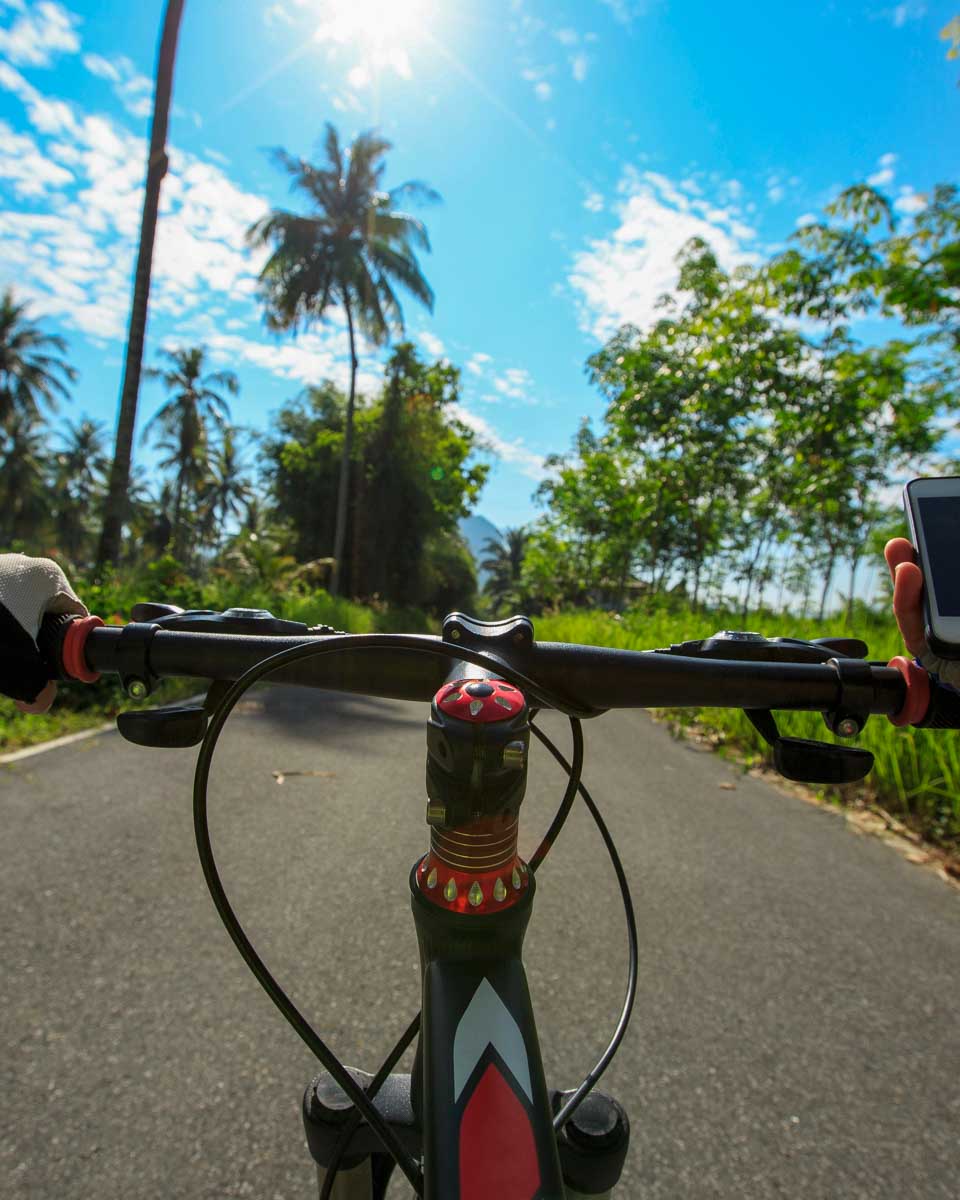 A-person-rides-a-bike-in-the-countryside-in Bali
