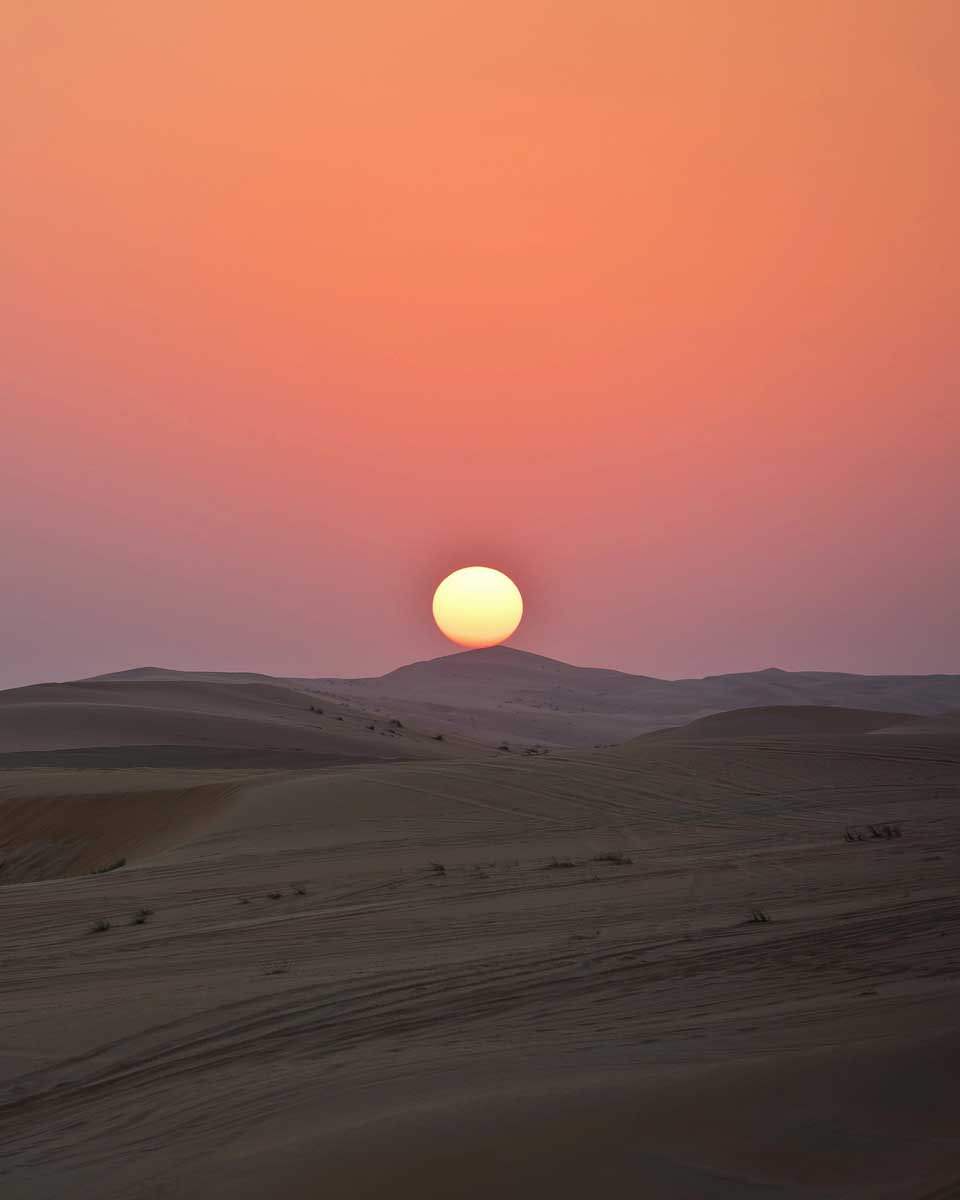 A sunset over the sand dunes in the Agafay desert, Morocco