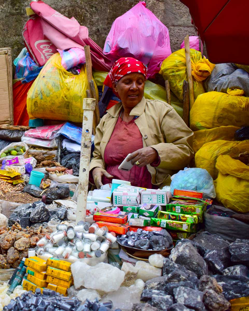 A woman sits at the Merkato Market in Addis Ababa Ethiopia