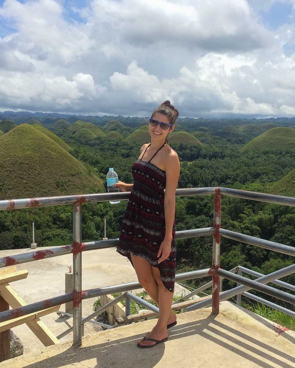 A woman smiles at the chocolate hills in bohol on a tour from Cebu Philippines