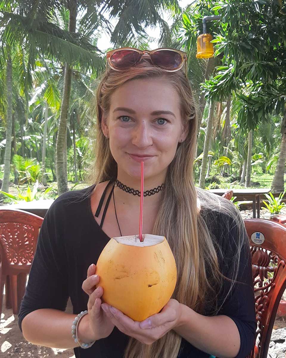 Bailey holds a coconut in St Lucia on a tour