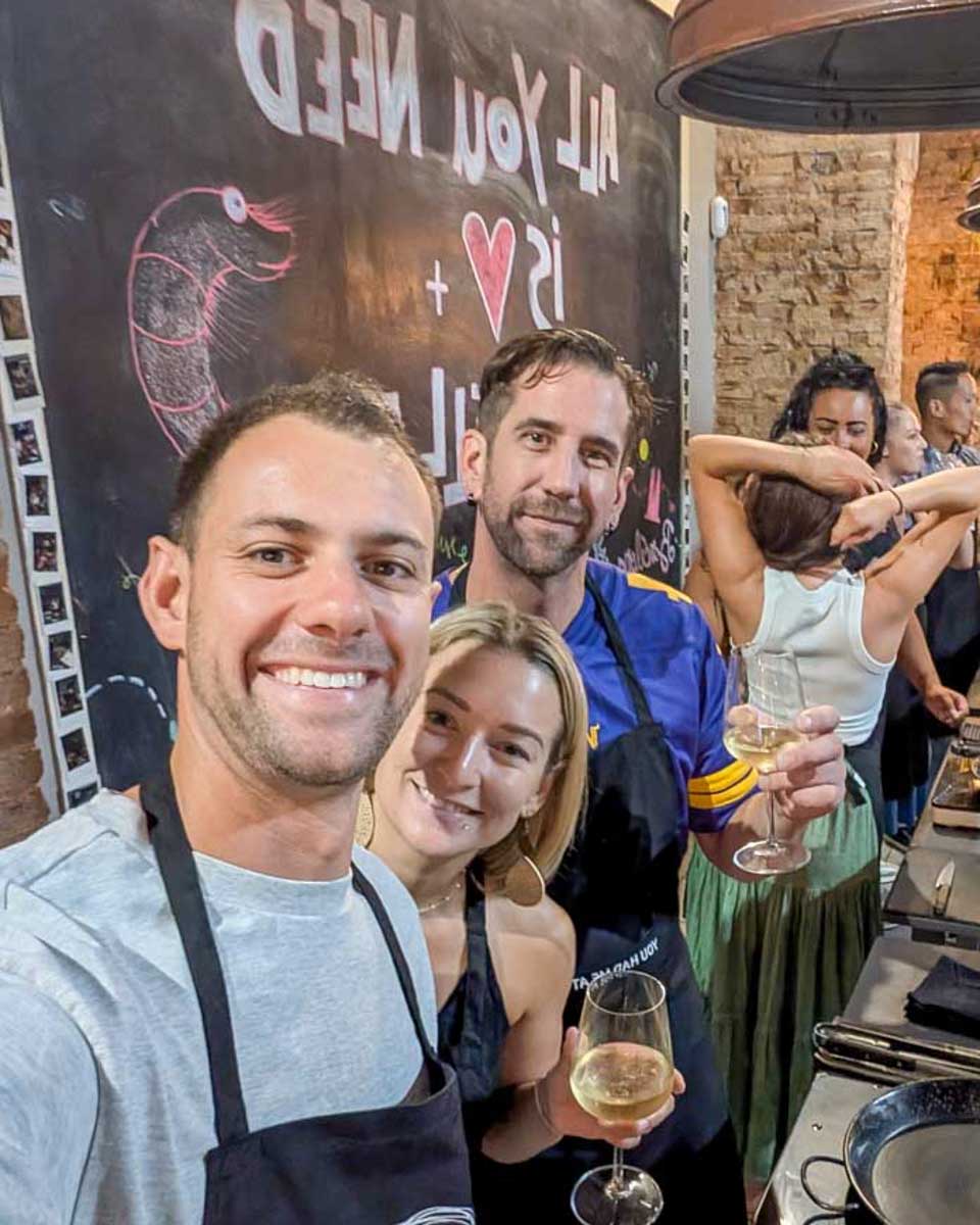 Daniel-and-Bailey-smiling-in-a-kitchen-during-a-Paella-making-class-in-Malaga-Spain